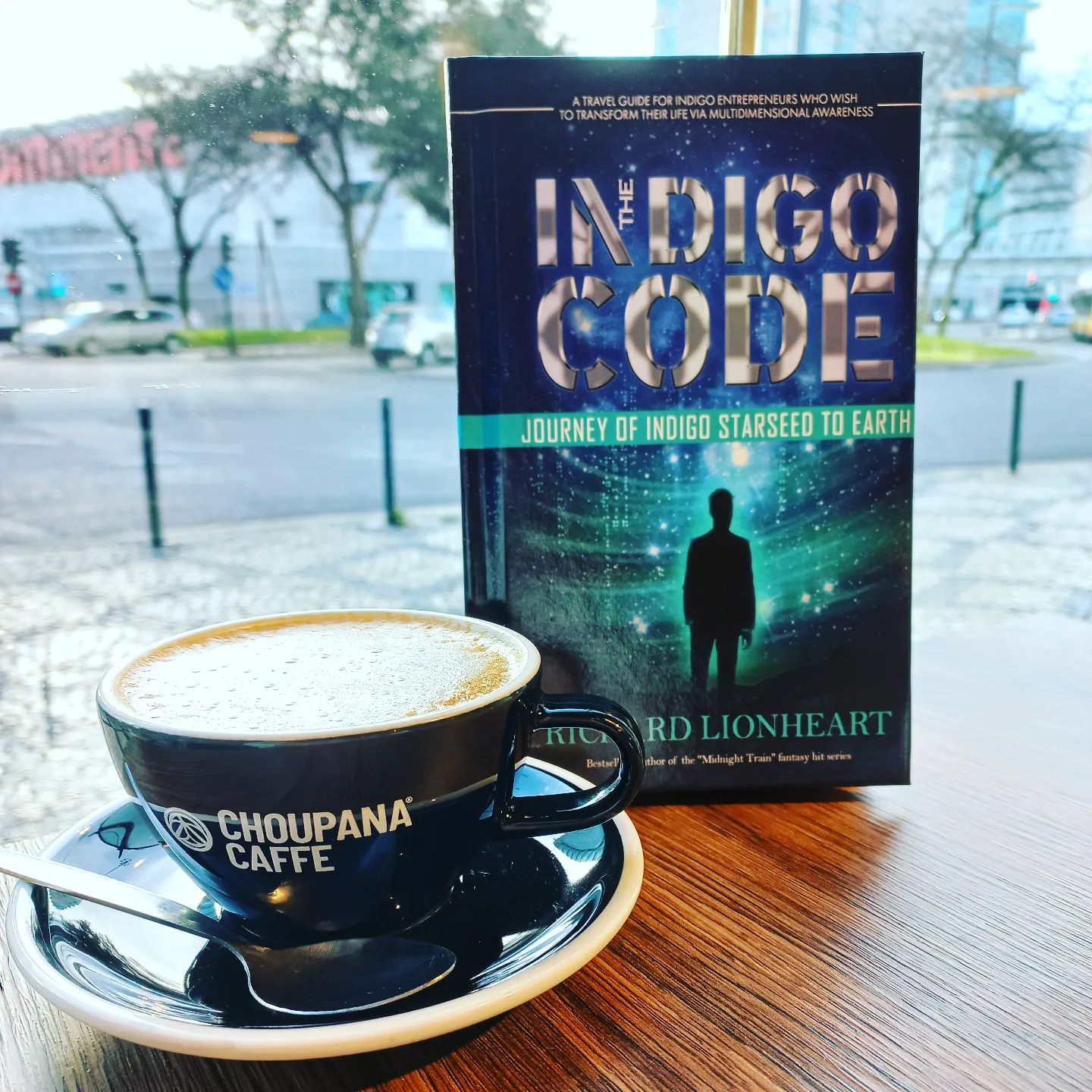 The Indigo Code Book Cover with a Coffee in Lisbon